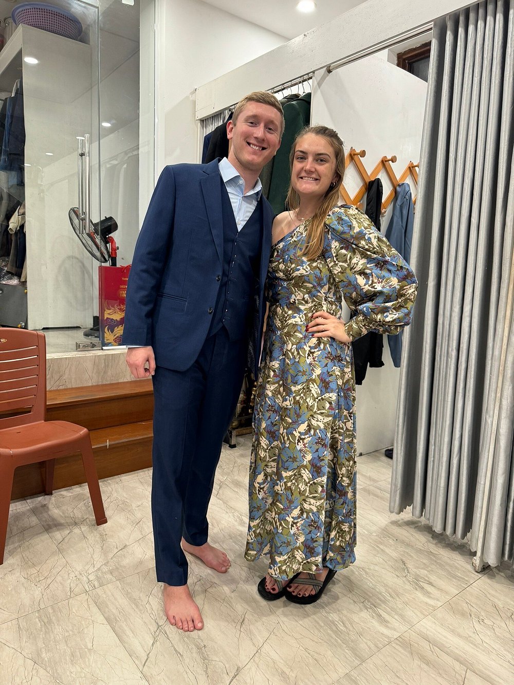 A customer wearing a bespoke navy two-piece suit in the THANH Design fitting room