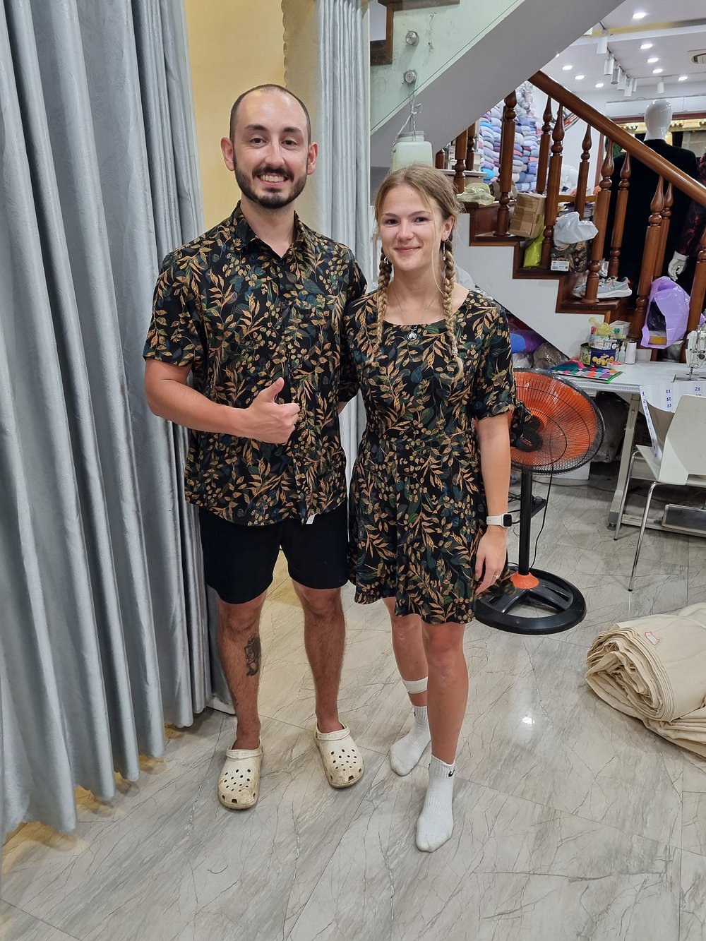 Two customers in matching custom-printed shirt and dress at THANH Design