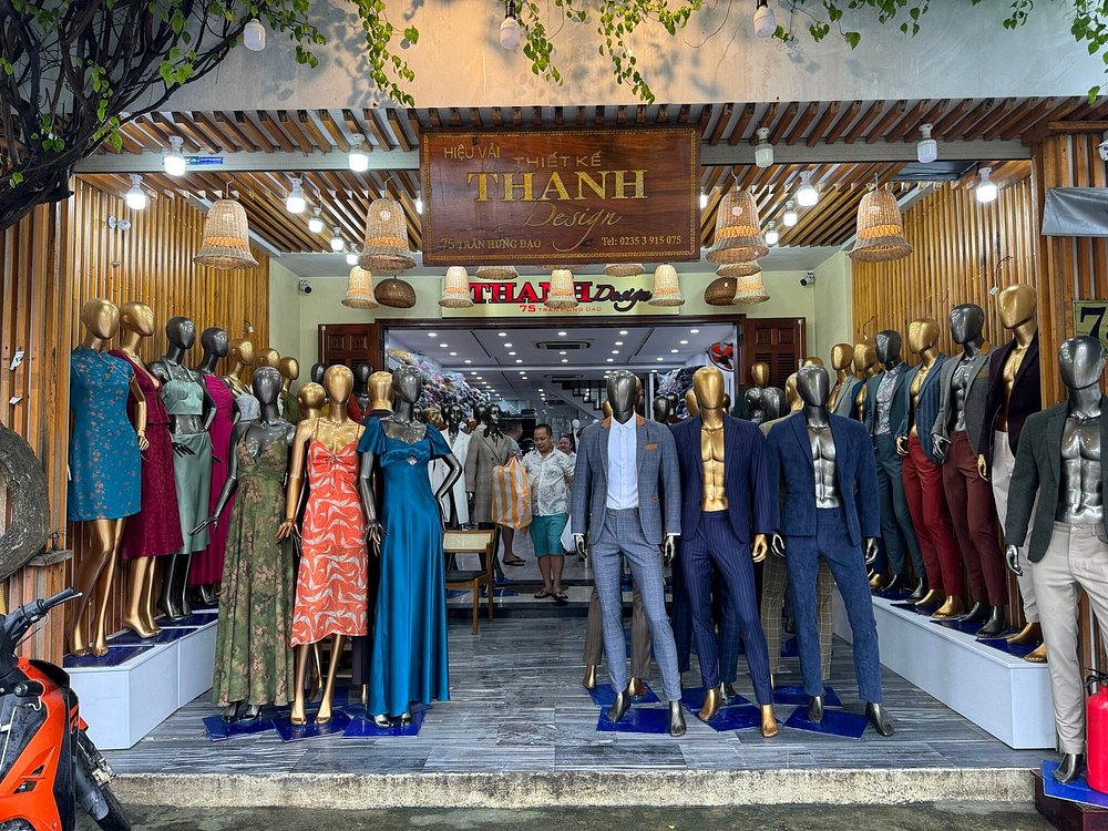 The THANH Design storefront at 75 Tran Hung Dao, Hoi An, with tailored suits and dresses on display