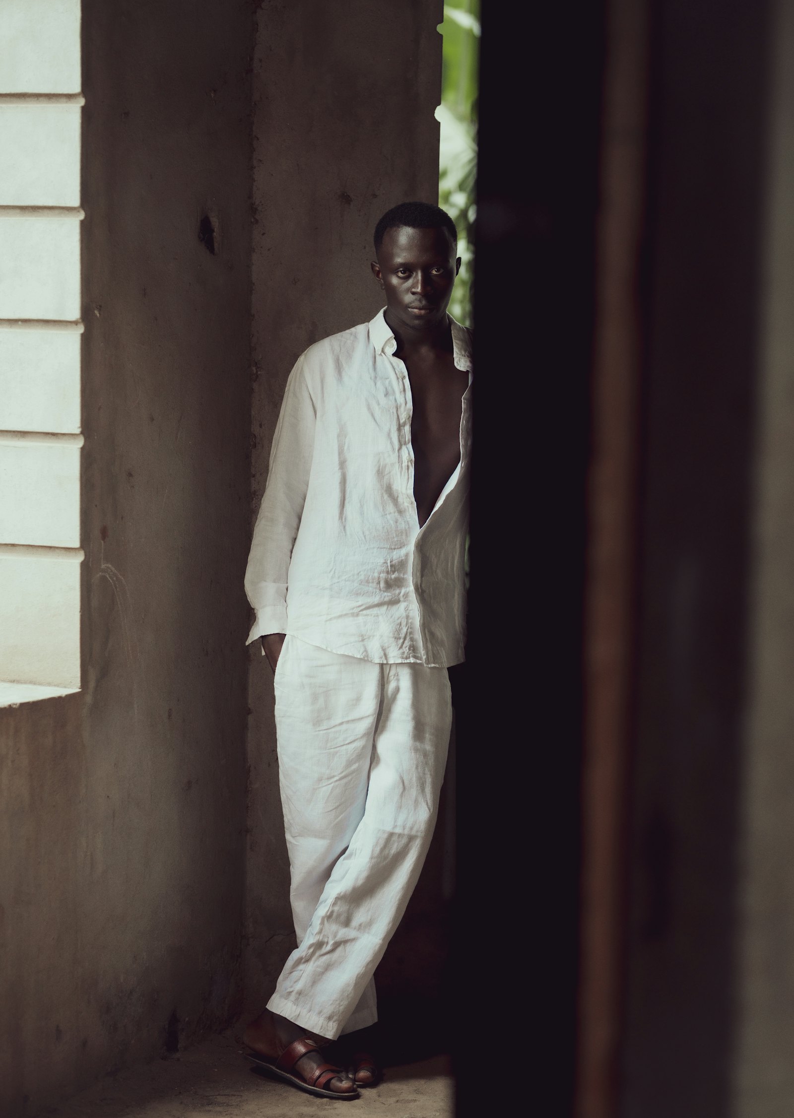 Man in a relaxed white linen shirt and matching linen trousers
