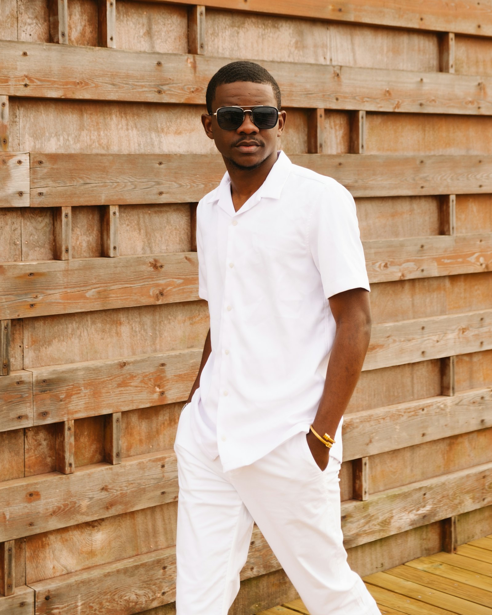 Man in a white short-sleeve linen shirt and white trousers