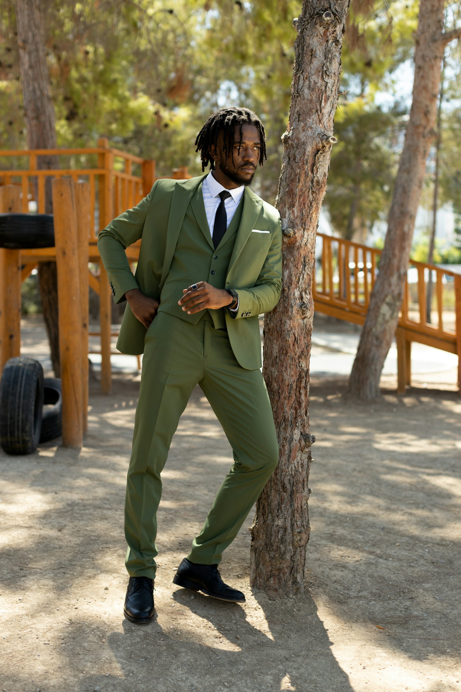 Man in a moss green three-piece suit